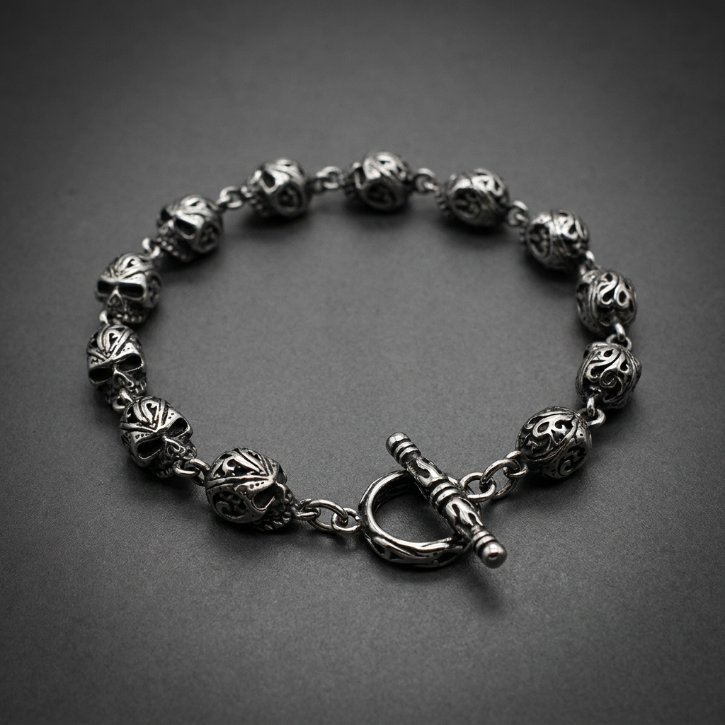 Silver 316L surgical stainless steel skull bracelet with detailed filigree patterns and a toggle clasp.