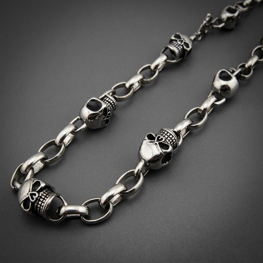 Highly polished 316L surgical stainless steel necklace featuring numerous individual skull links with detailed features.