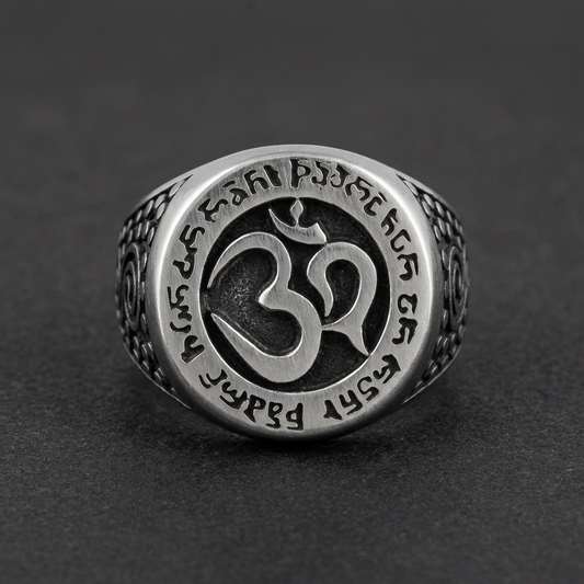 A close-up of the Om d'Ombre Ring, showcasing the dark Om symbol surrounded by tribal patterns on 316L stainless steel with oxidized details.