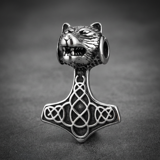 Heavy-duty 316L stainless steel Mjolnir pendant with a snarling wolf's head gripping the hammer and Celtic knots on the hammerhead, in silver finish.