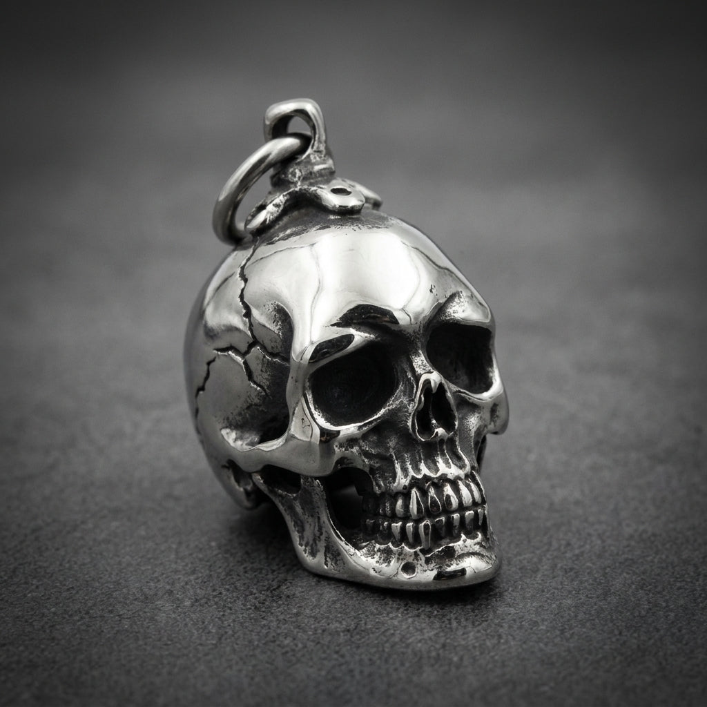 Heavy-duty 316L stainless steel skull pendant with oxidized details and a high-polish finish, held in a hand.