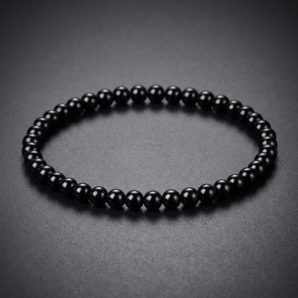 A minimalist, polished bracelet crafted from spherical black 316L stainless steel beads, strung tightly together.