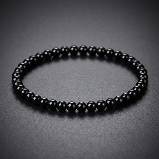 A minimalist, polished bracelet crafted from spherical black 316L stainless steel beads, strung tightly together.