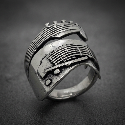 Polished ribbed ring made from 316L surgical stainless steel, featuring deep parallel grooves and rivets, silver in color.
