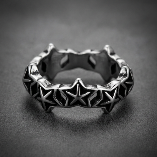 Polished Star Band ring in 316L stainless steel, featuring continuous raised five-pointed stars with dark etched details, against a light background.