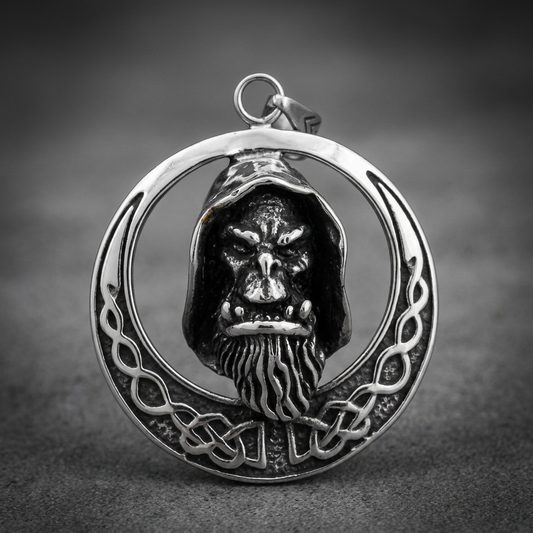 Refined Grim Oracle pendant in 316L stainless steel, featuring a hooded, bearded oracle head within a detailed Celtic knotwork crescent moon design, dark oxidized finish.