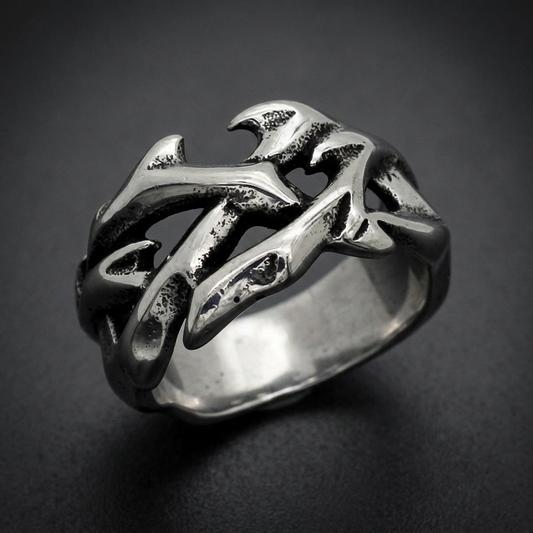 Wide 316L surgical stainless steel ring with an abstract, organic wave-like or flame-like pattern, featuring dark oxidized details against a polished silver finish.