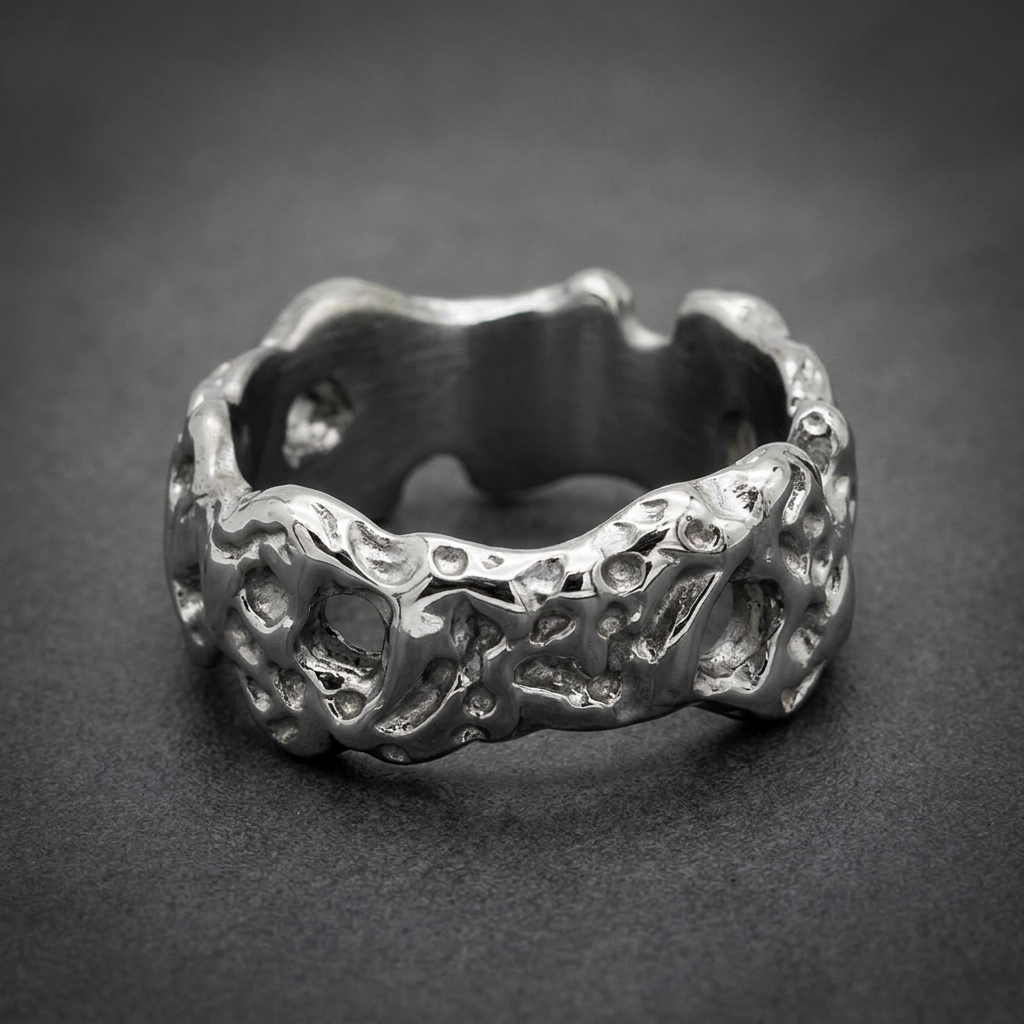 Reflexive Flow Ring, 316L surgical stainless steel, bright silver color, heavily textured and pitted surface resembling molten rock, HardKnocker solid-back design.