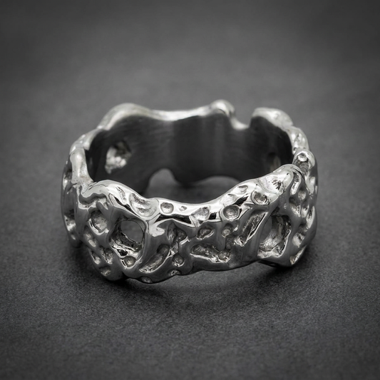 Reflexive Flow Ring, 316L surgical stainless steel, bright silver color, heavily textured and pitted surface resembling molten rock, HardKnocker solid-back design.