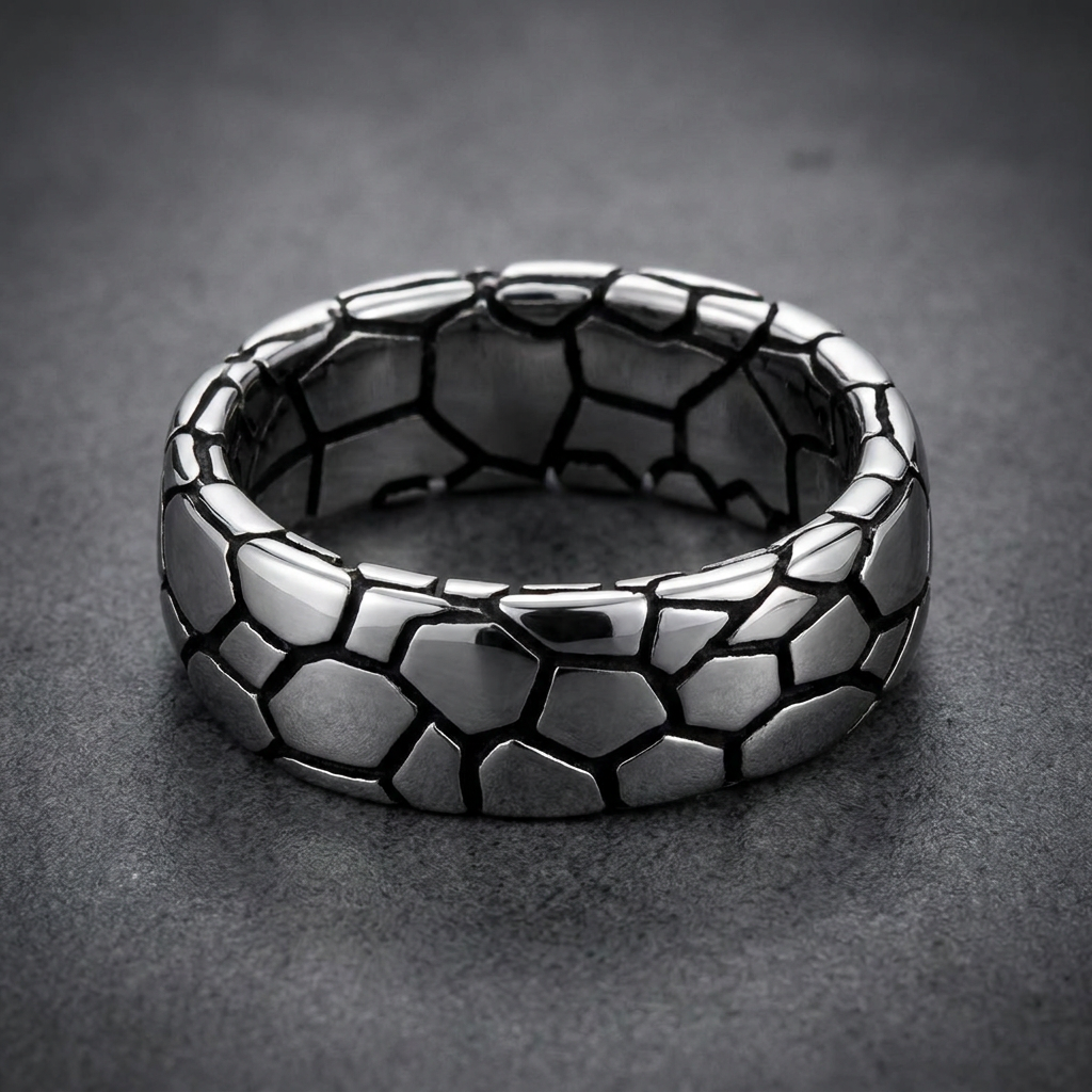 Wide 316L surgical stainless steel ring with a geometric, segmented pattern, bright silver polished segments with dark recessed lines, robust HardKnocker™ style.