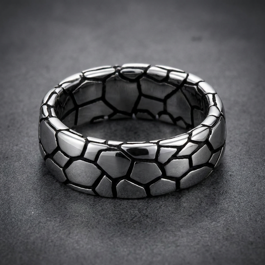Wide 316L surgical stainless steel ring with a geometric, segmented pattern, bright silver polished segments with dark recessed lines, robust HardKnocker™ style.