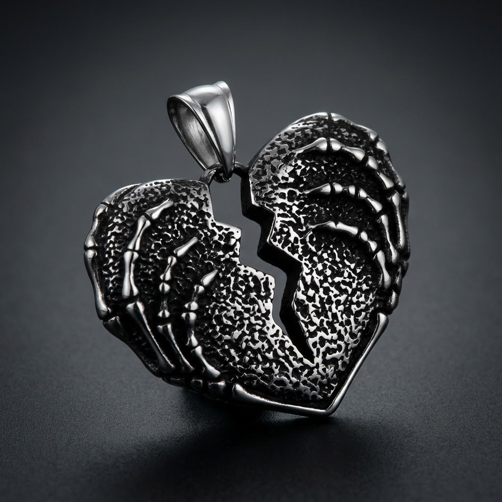 Shattered Soul Pendant made of 316L stainless steel, featuring a broken heart design gripped by skeletal hands with an oxidized gothic finish.