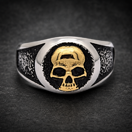 Unisex two-tone gold face skull ring in 316L surgical stainless steel, with a black oxidized and textured band.