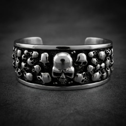 Bad Company Multi-Skull Bangle Bracelet made of 316L stainless steel featuring multiple sculpted skull designs with an oxidized finish.