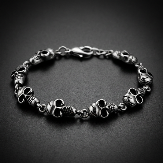 Close-up of a "Road Skull Bracelet" showing detailed 316L surgical stainless steel skulls with an antique finish, representing biker and road culture.