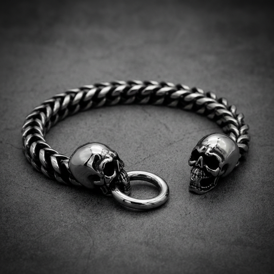 Iron Skulls Conquest double skull bracelet in polished 316L surgical-grade stainless steel, with a foxtail chain.