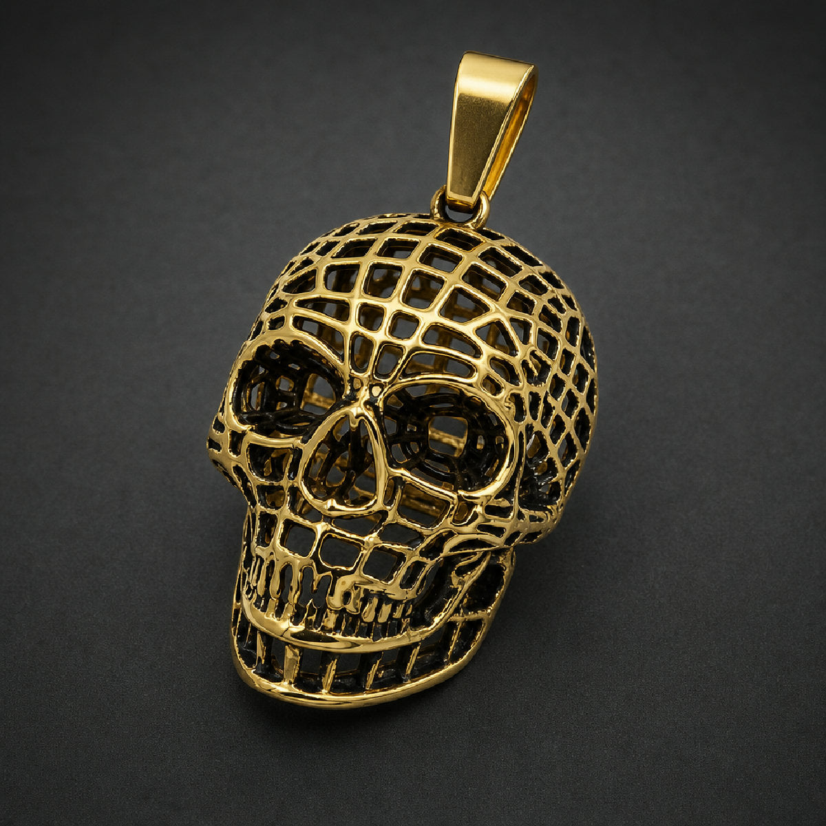 Gold 316L stainless steel caged skull pendant featuring an openwork lattice frame and heavy bail
