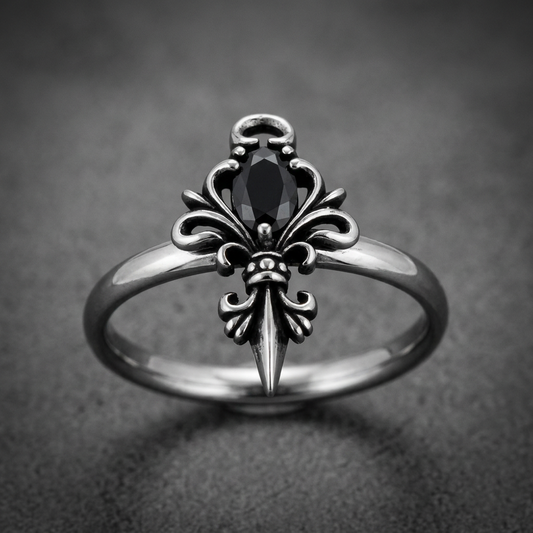 Sovereign Fleur Ring, 316L surgical stainless steel, dark finish, featuring a prominent fleur-de-lis with a marquise-cut black stone.