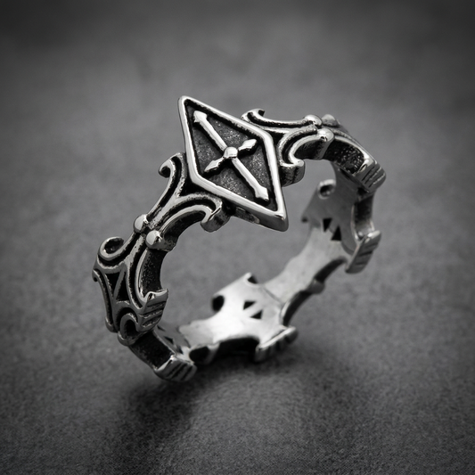 Sovereign Shield Unisex Ring, crafted from 316L stainless steel, featuring a central shield motif with a cross and ornate side scrollwork, dark oxidized finish.