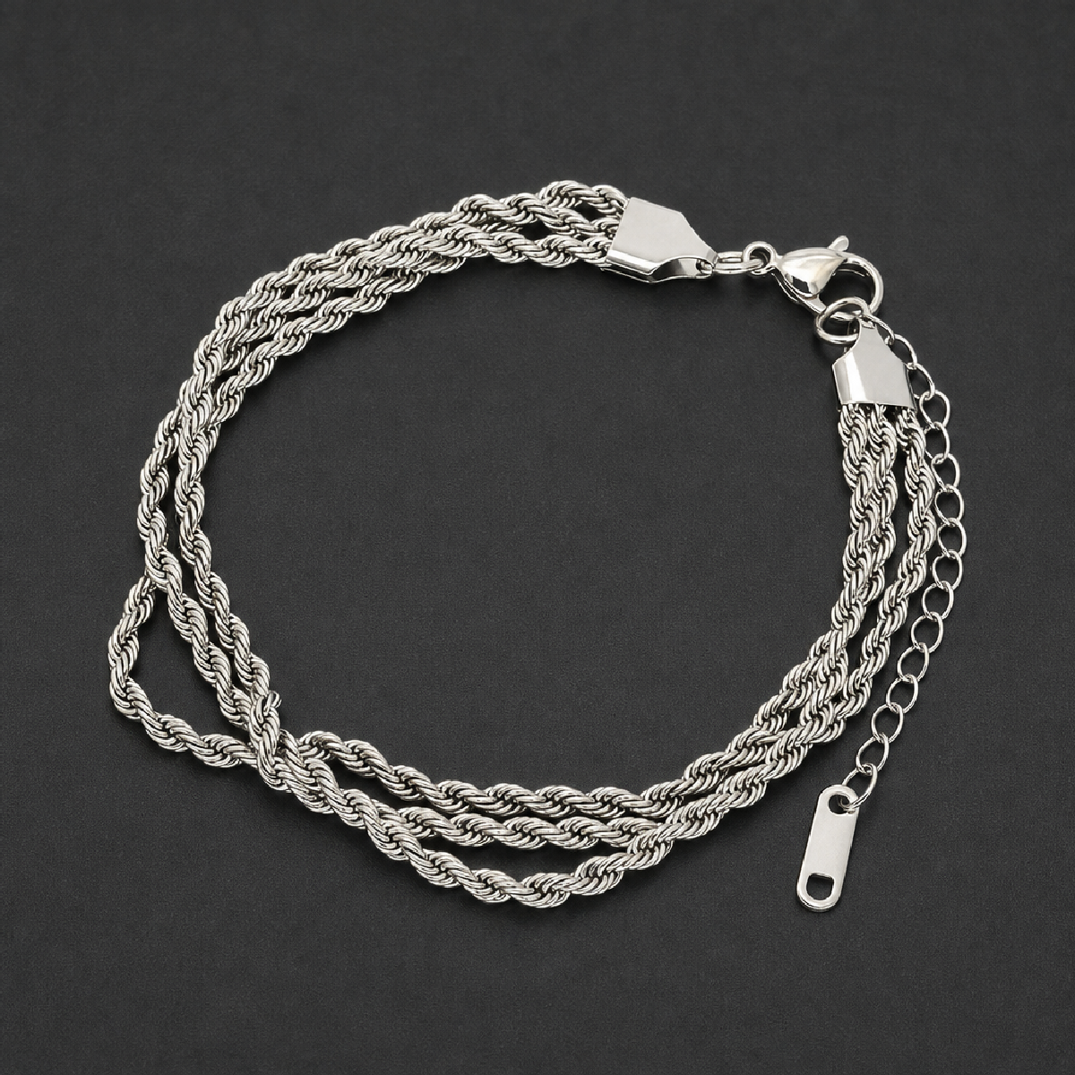 Triple Rope Bracelet in bright 316L surgical stainless steel, featuring three intertwined rope chains, a lobster clasp, and an extender chain, on a white background.