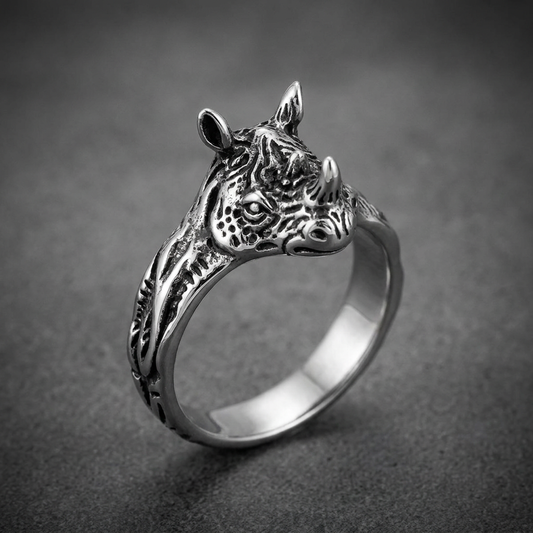 Heavy 316L stainless steel ring featuring a highly detailed, aggressive rhino head. The silver finish has darkened recesses for contrast.