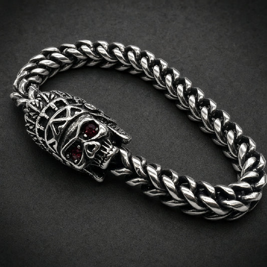 316L stainless steel warbonnet skull bracelet featuring faceted red gemstone eyes and an oxidized braided wheat chain