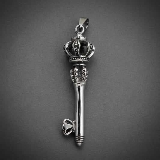 A heavy 316L surgical stainless steel pendant shaped like an ornate key with a crown at the top, polished to a bright finish.