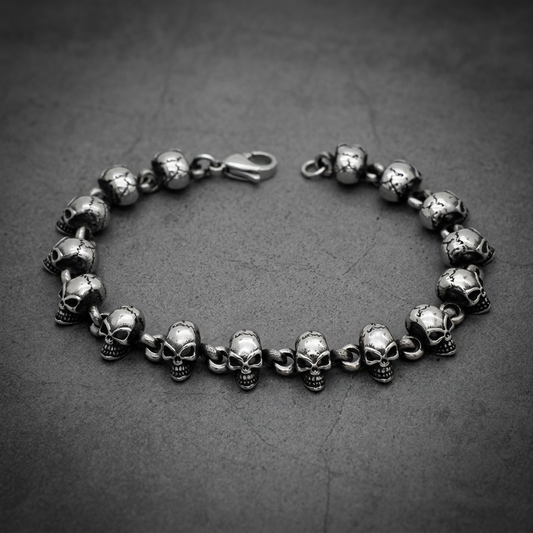 Heavy 316L stainless steel bracelet featuring twenty grim skull links with dark oxidized detailing, connecting with a sturdy lobster clasp.