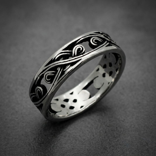 Unisex 316L stainless steel ring with intricate polished and blackened swirl pattern on a white background.