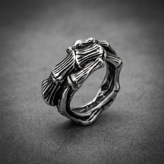 Heavy 316L stainless steel ring with an intricate, layered bone-like texture and dark oxidized recesses, unisex style