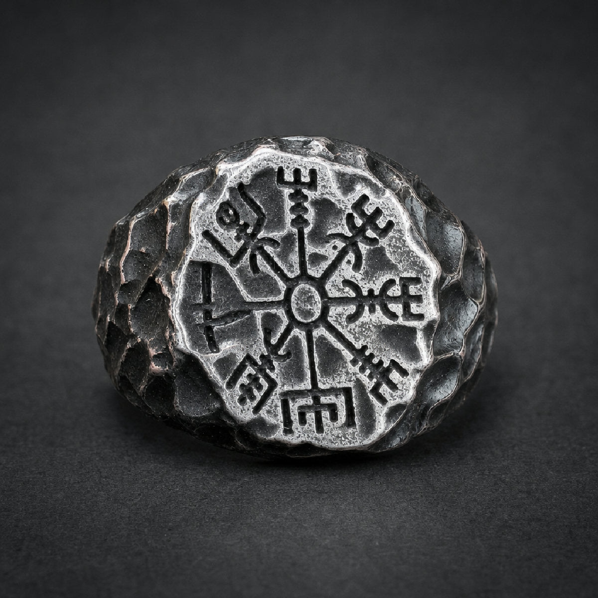 Heavy 316L stainless steel HardKnocker ring with a deeply etched, antiqued Vegvisir symbol on a textured, dark face.
